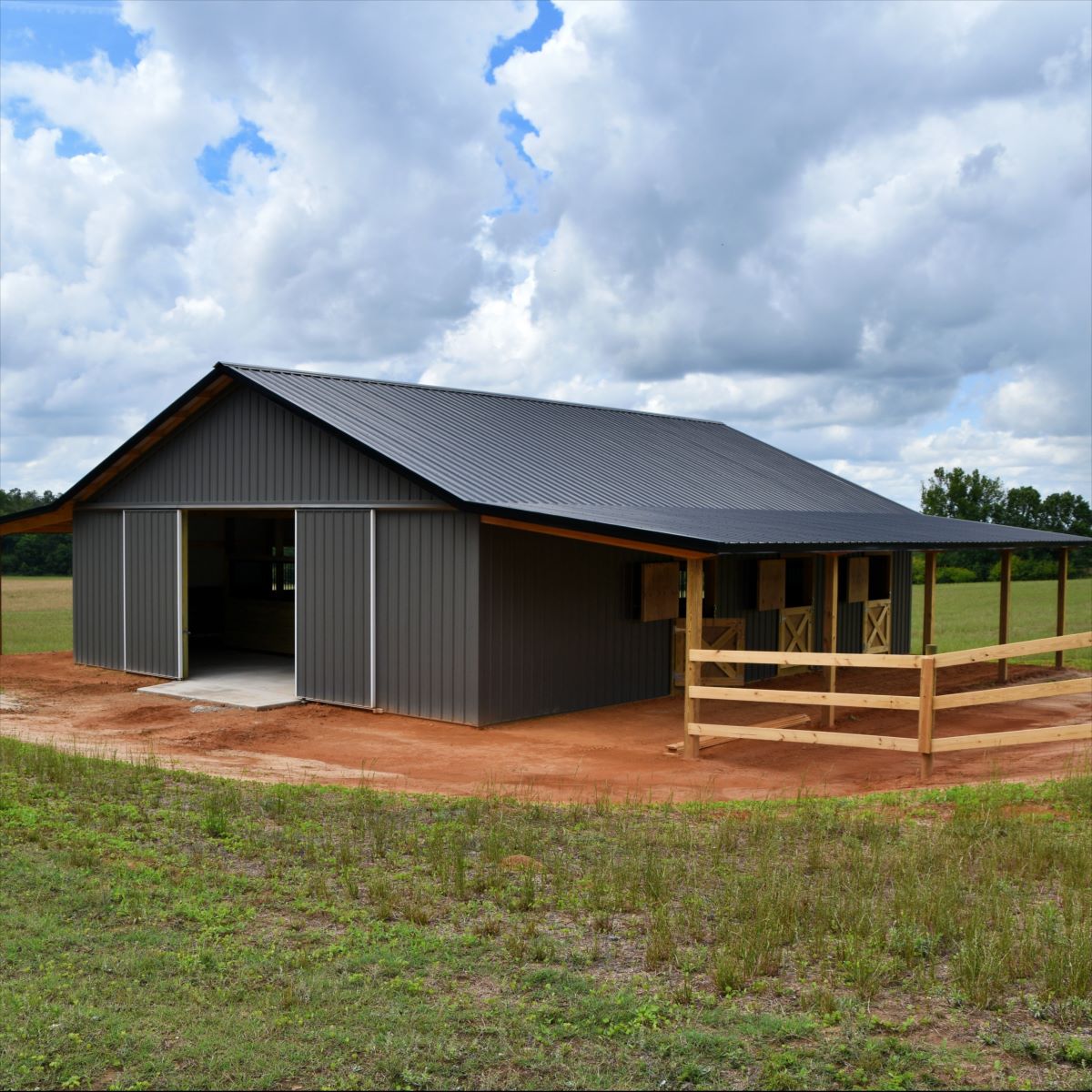 Modern gray barn showcasing one use for a Texas metal building for your residential construction project.